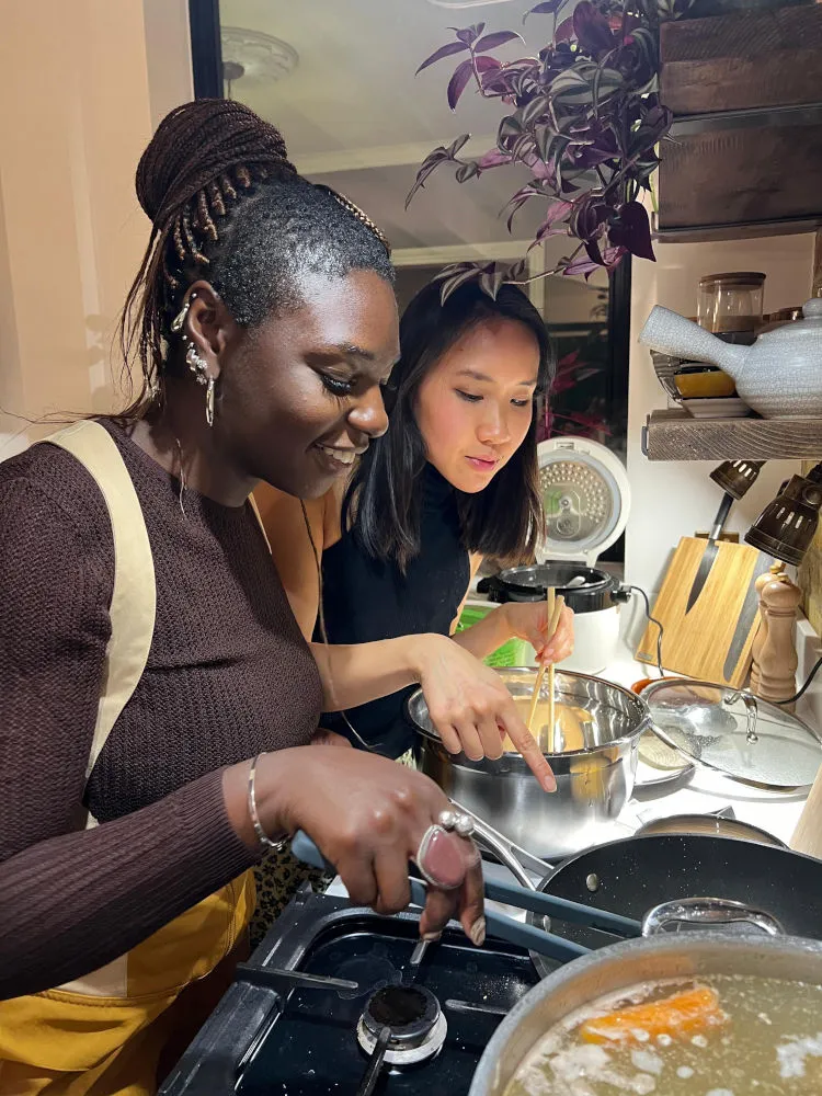 Two people cooking prawn crackers